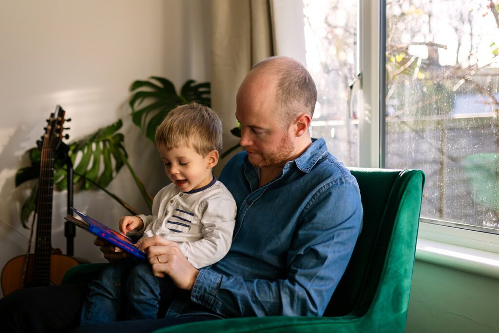 father reading to his toddler child