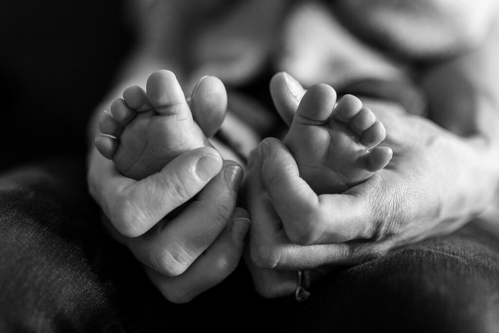 baby toes in mother's hands