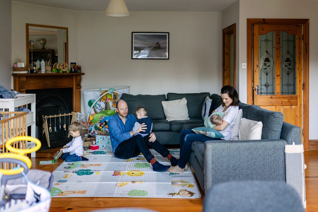 family during a In home twin baby photos with sibling