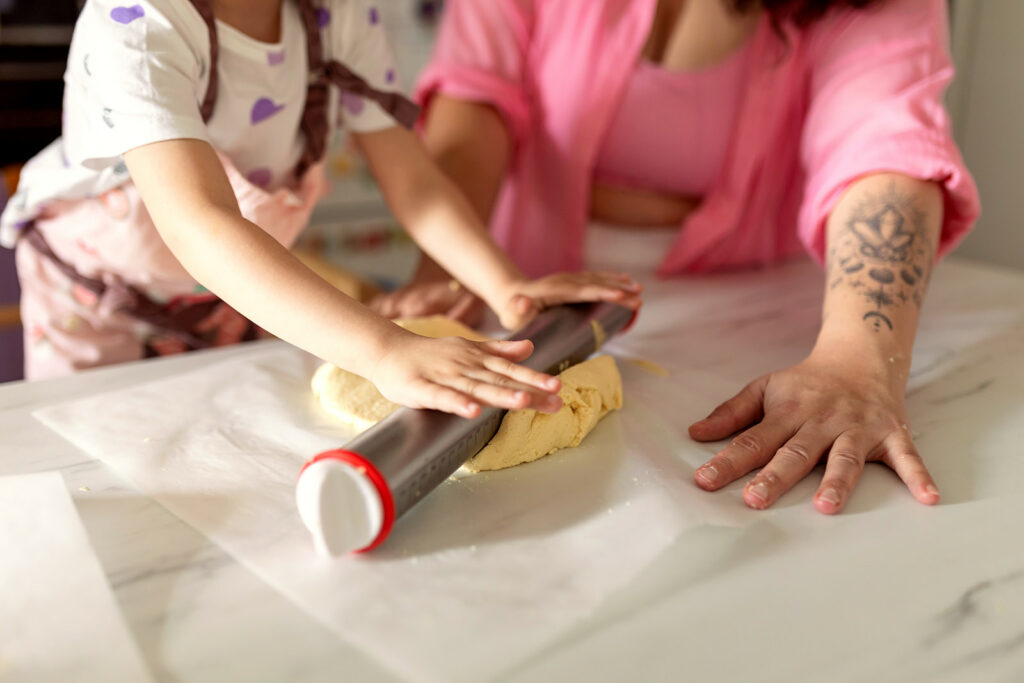 mother and child baking cookies at home