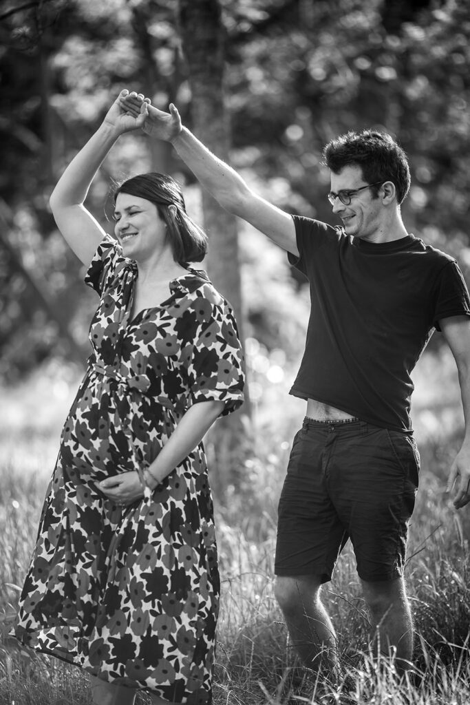 parents dancing together at the park during their family photoshoot