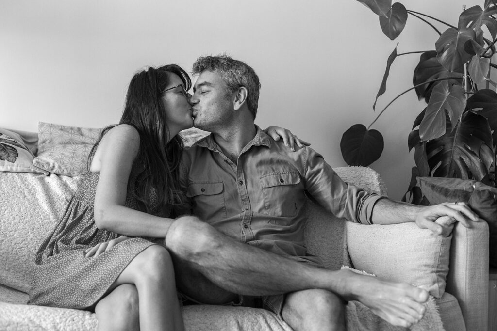 parents at home kissing and smiling