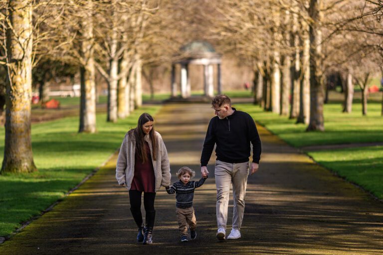 family walking hand in hand for a winter photoshoot, Family photography Memorial Garden Dublin