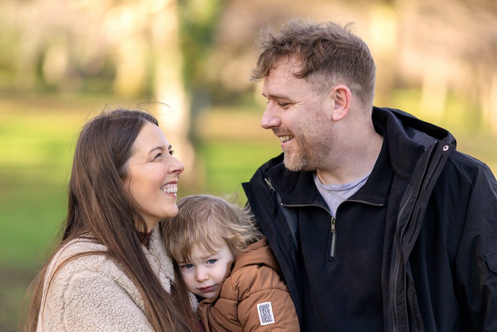 family smiling and looking fondly at each other