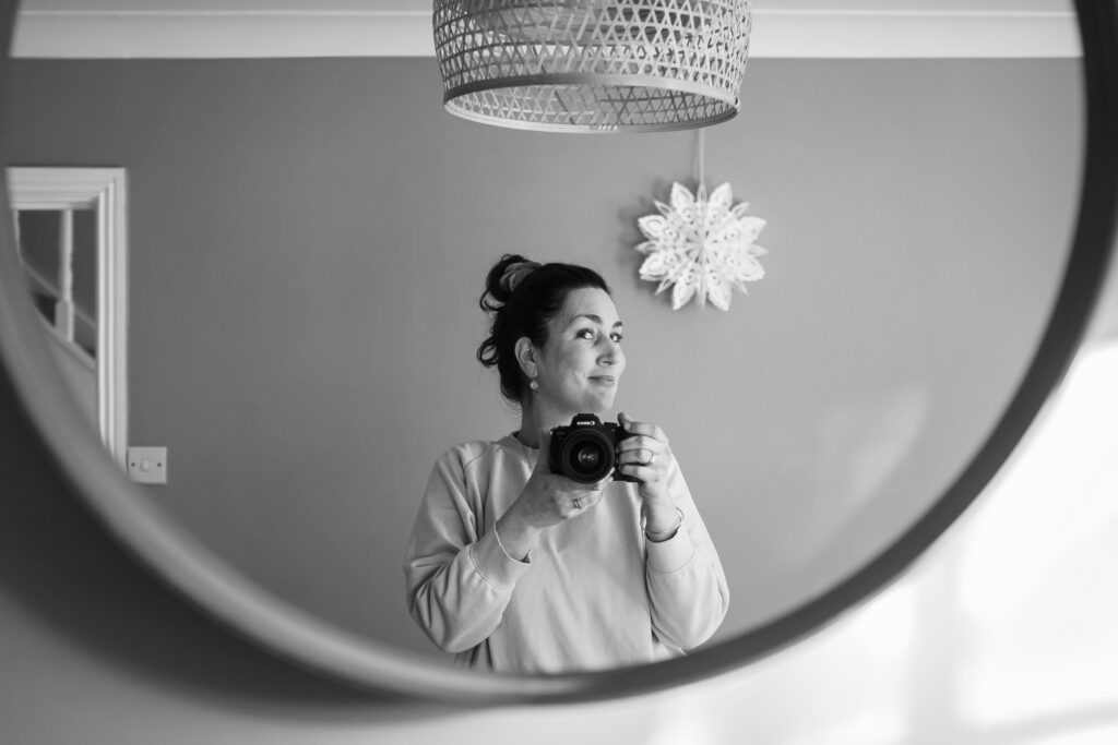 Aurélie Lenoir taking a self-portrait with her camera at home
