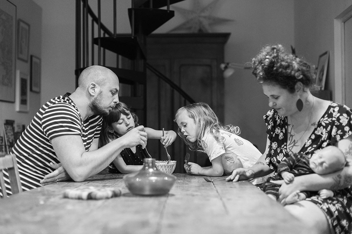 a family enjoying a snack at the kitchen table