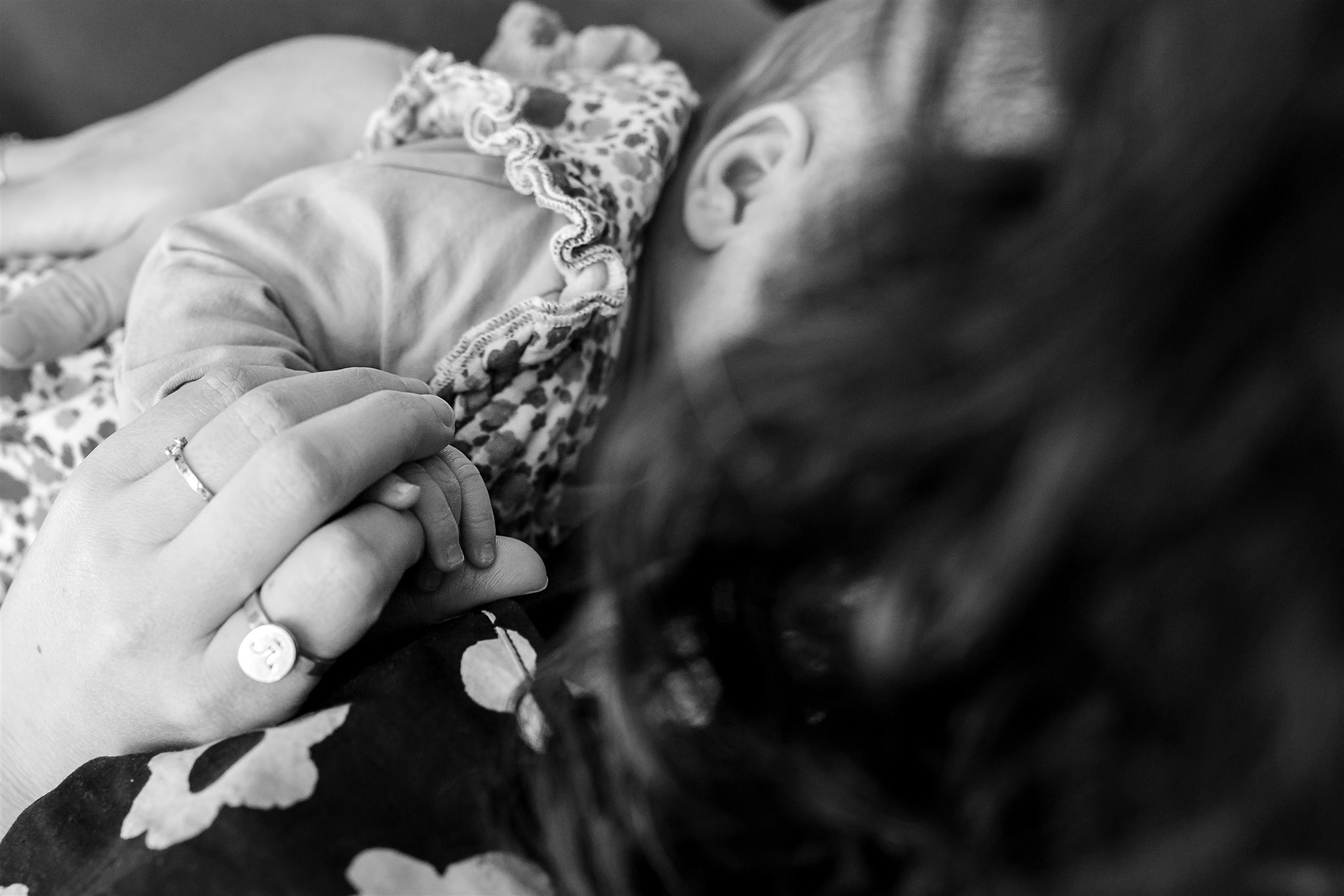 details of mom's hand holding newborn