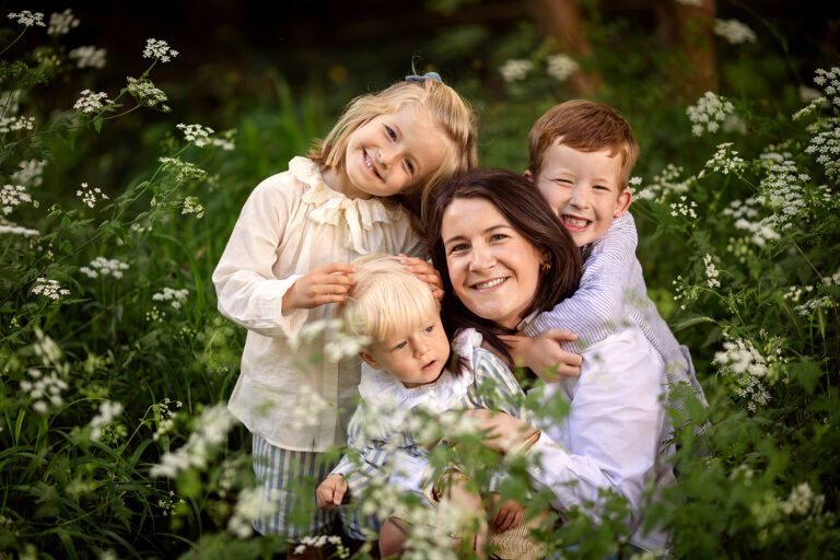 mother and kids smiling and posing for family photo for grandparents