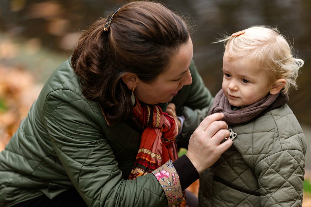 mum cuddling her kid at the park during an Autumn family photo session in Dublin