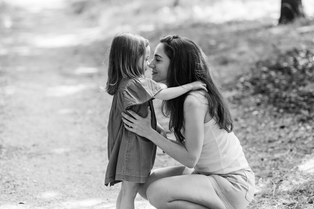 mum and her daughter cuddling at the park