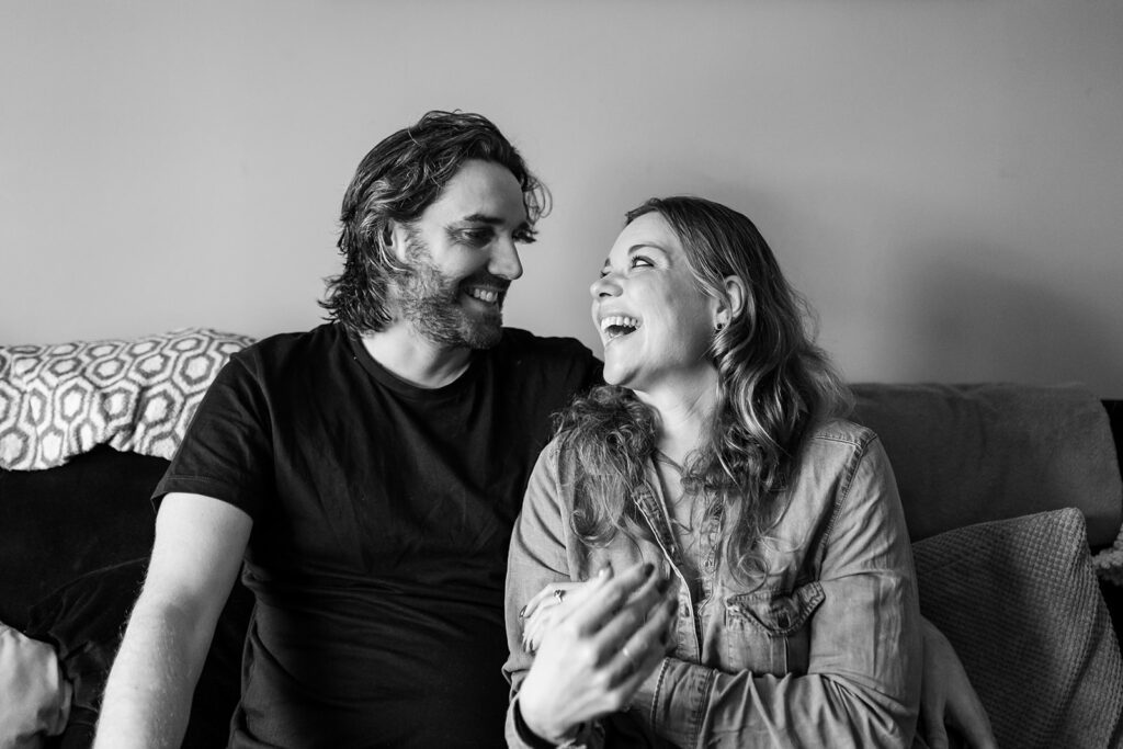 couple smiling and laughing at home