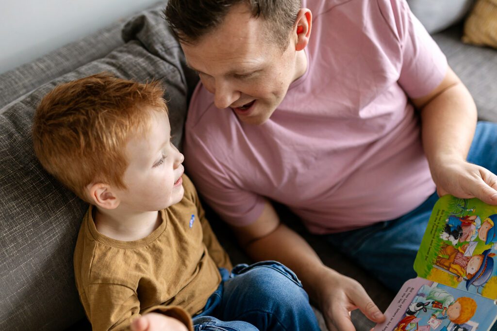 dad reading to his child at home