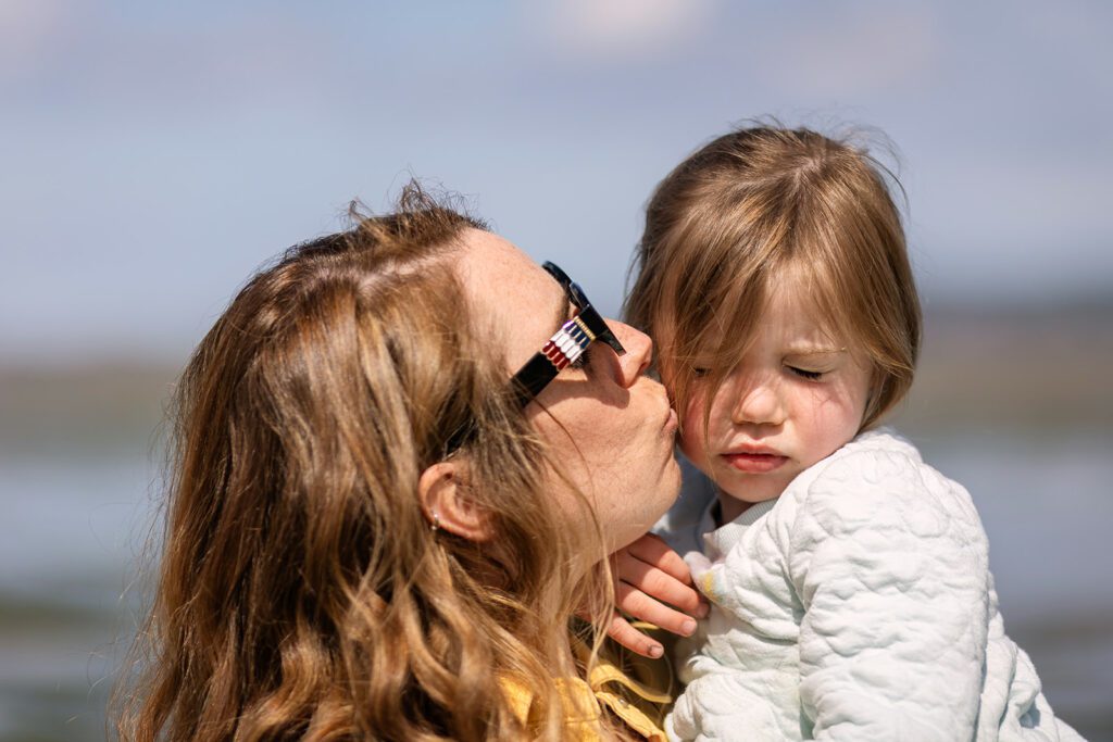 mum kissing her little girl in sandymount Dublin