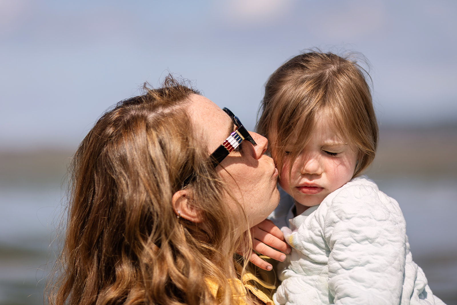 mum kissing her little girl in sandymount Dublin