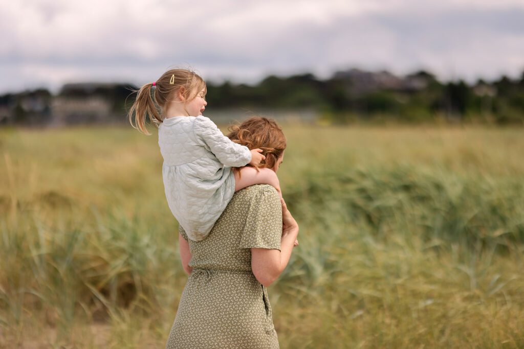 mother holding her child on her back