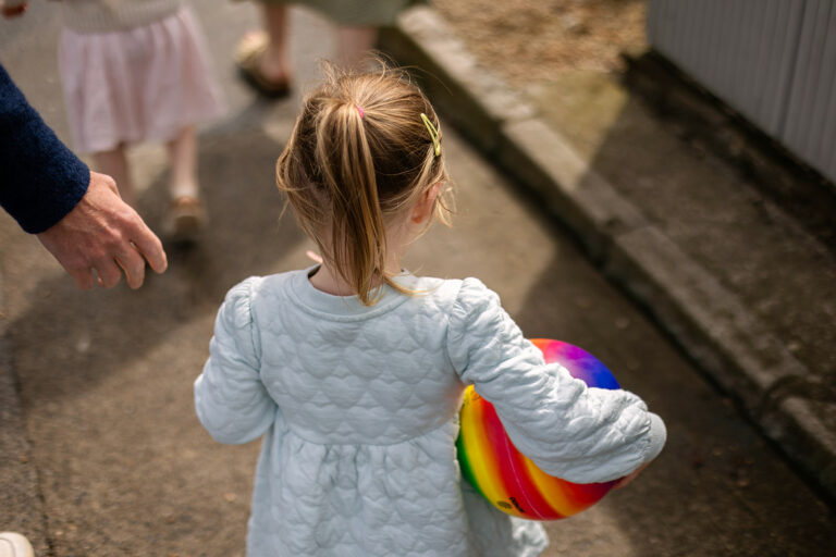 little girl holding a ball