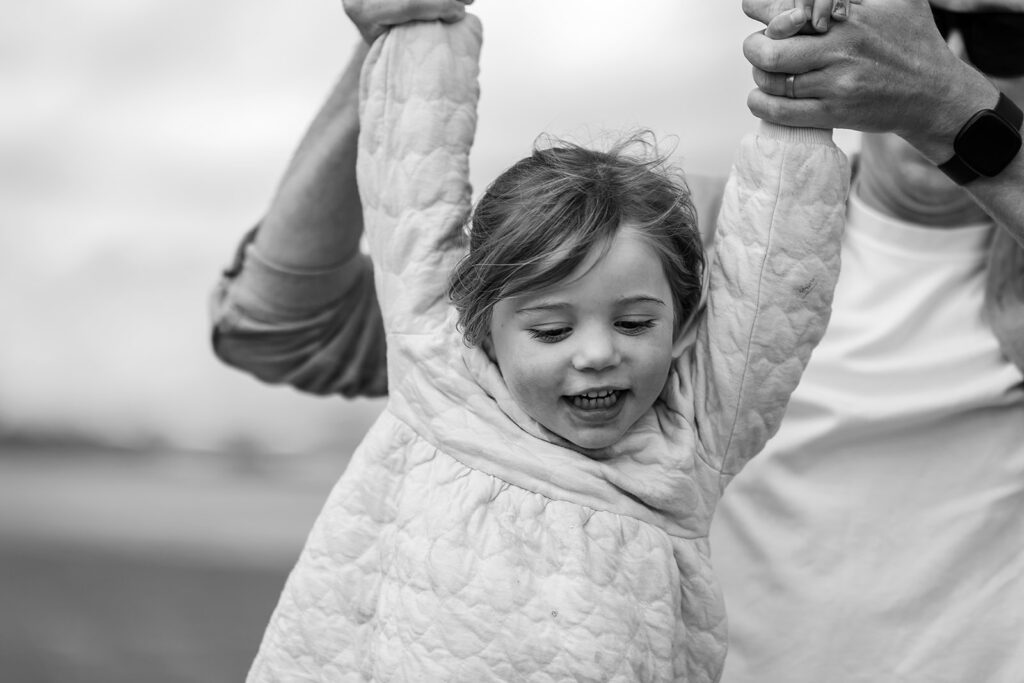little girl playing with dad on the Sandymount beach