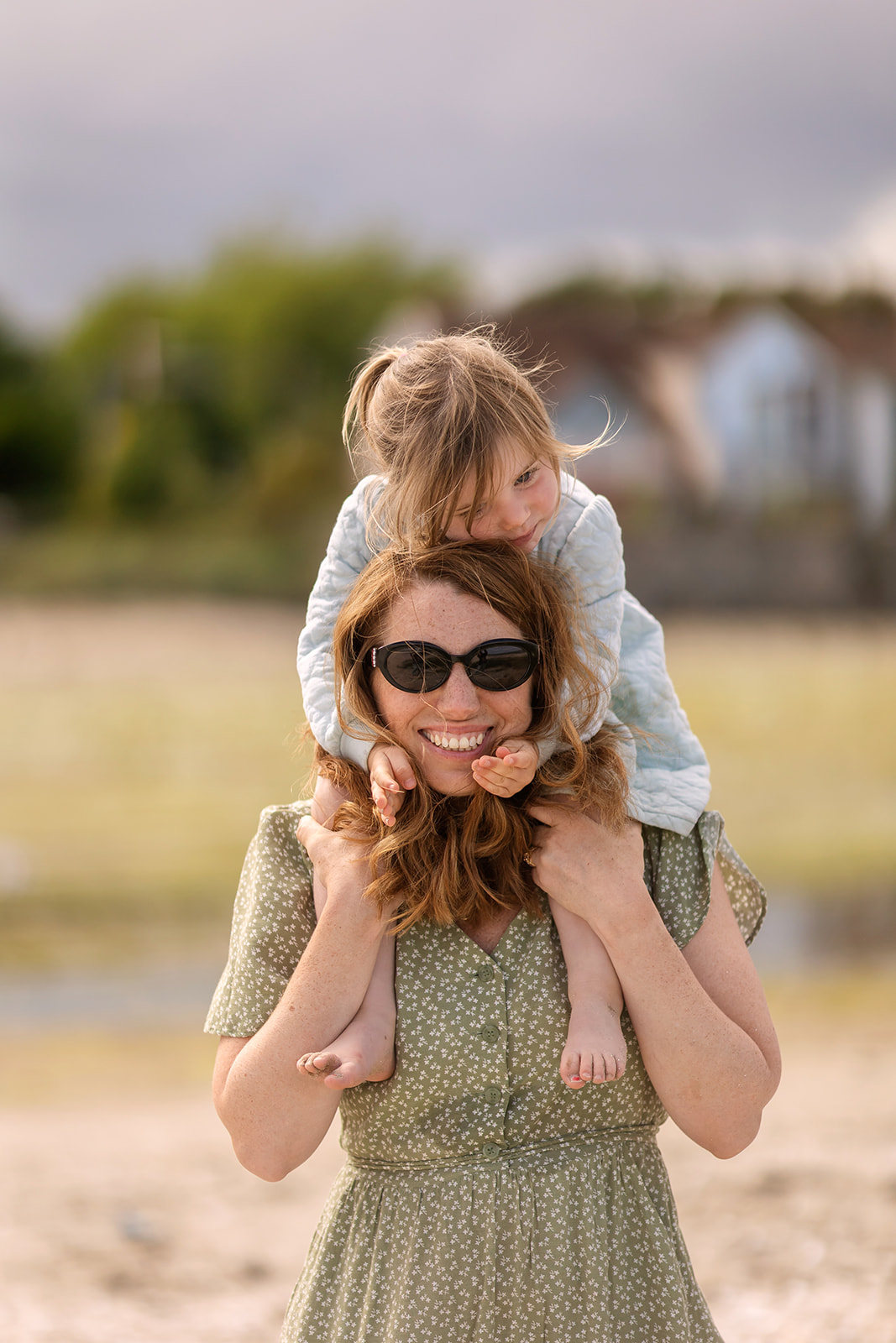 Mother smiling with her toddler outdoors in Sandymount