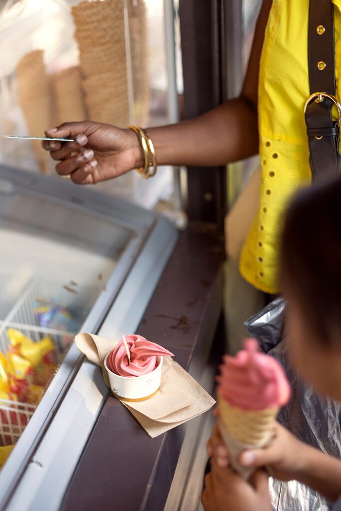 mother buying ice cream to her kids during a photo session