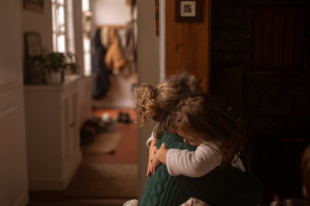 mother hugging her child at home