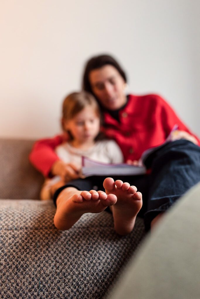mum reading to her child at home during a solo mum family photo session