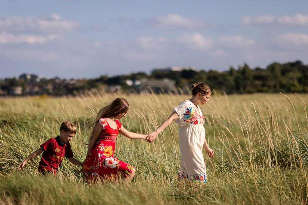 family walking hand in hand on the beach for a Vacation photographer in Dublin