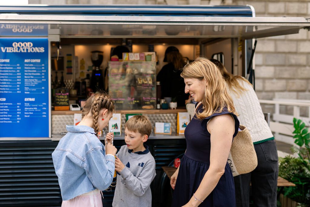 family buying a drink from a foodtruck in Trinity college