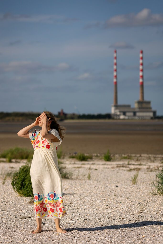 mother posing in front of the Poolberg chimneys for a Vacation photographer in Dublin