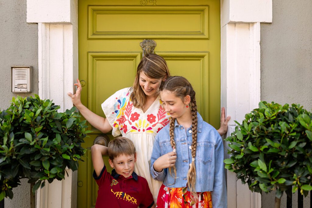 family posing in front of colorful Dublin door