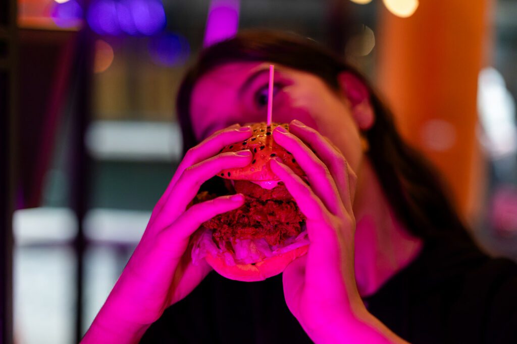 little girl eating a burger at the Saucy Cow in Dublin, book a family photo shoot while visiting Dublin