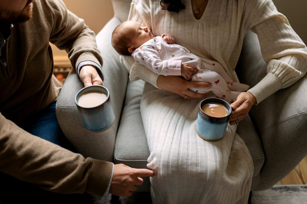 parents having tea and cuddling newborn during a Day in the life family photography Dublin