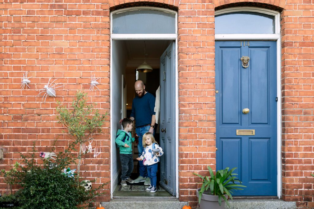 kids and dad heading out of their Dublin home for a Day in the life family photography Dublin