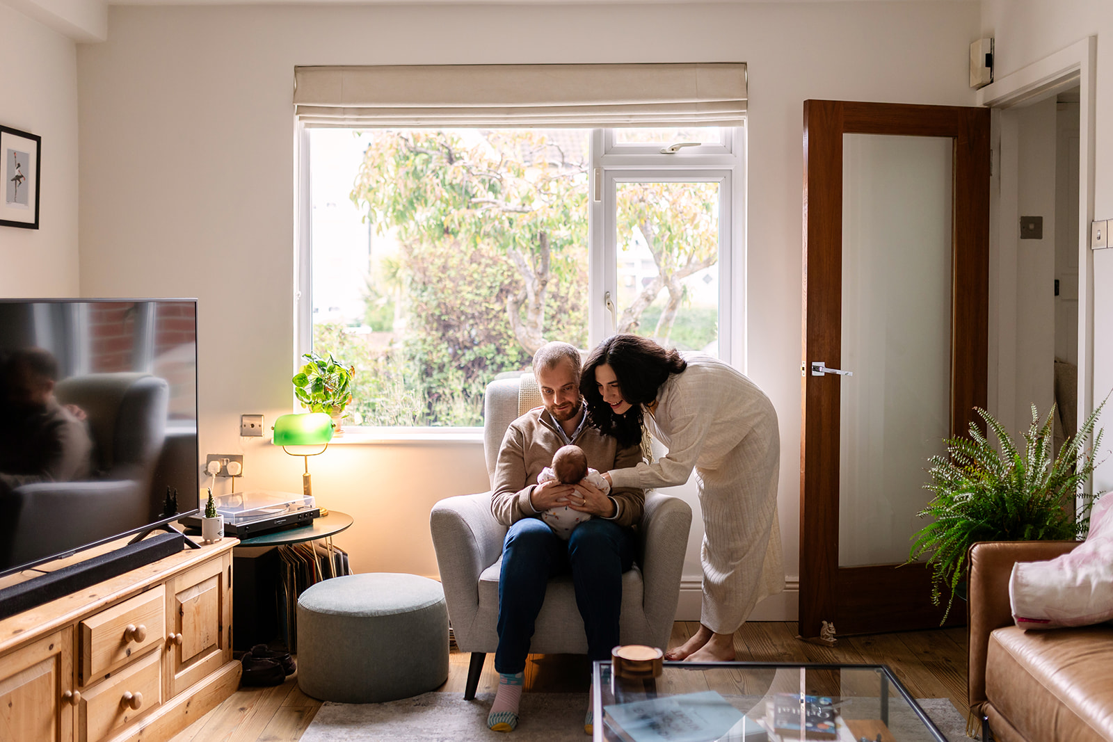 parents and newborn in their living room during a Home family session in Dublin