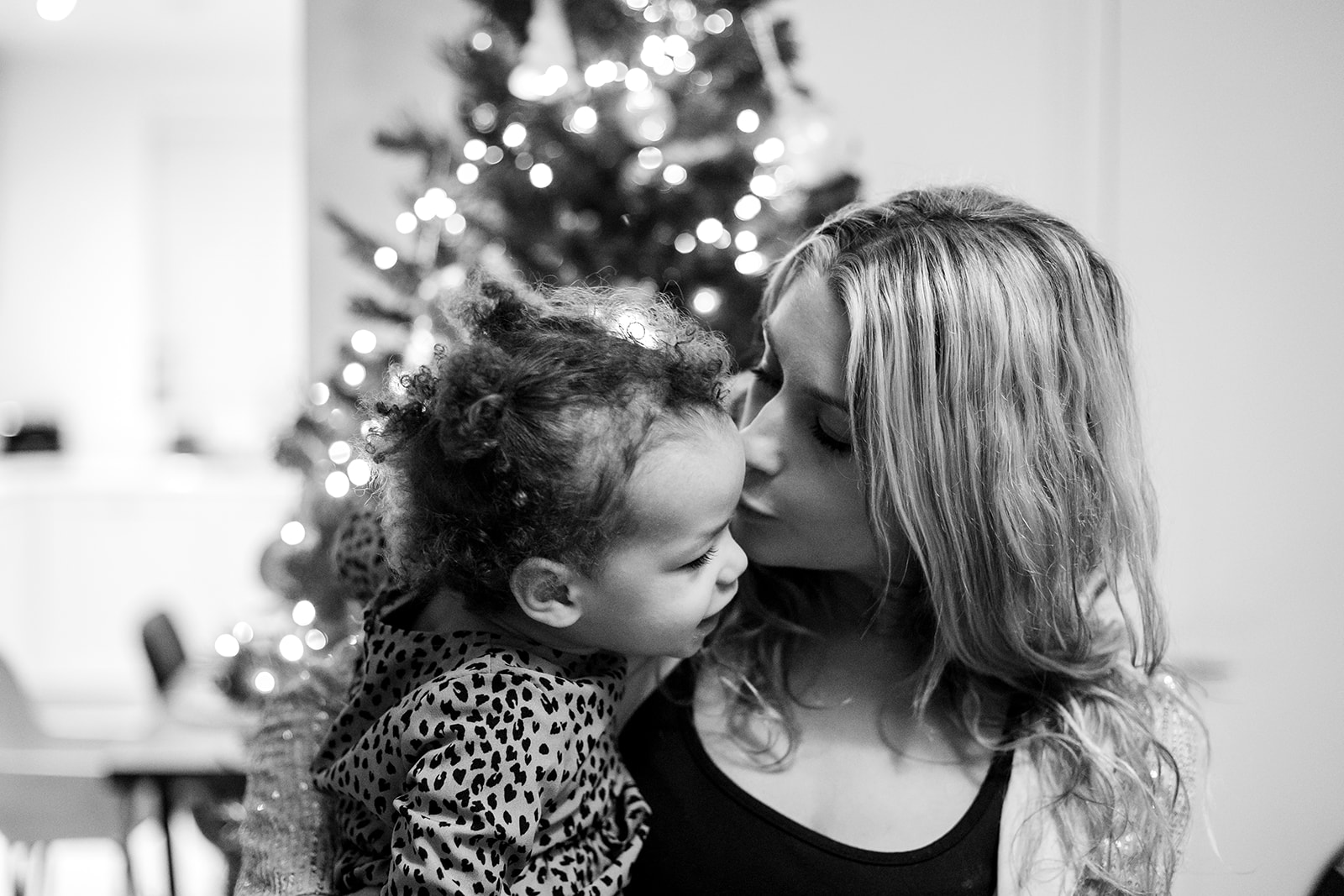 mom kissing her daughter