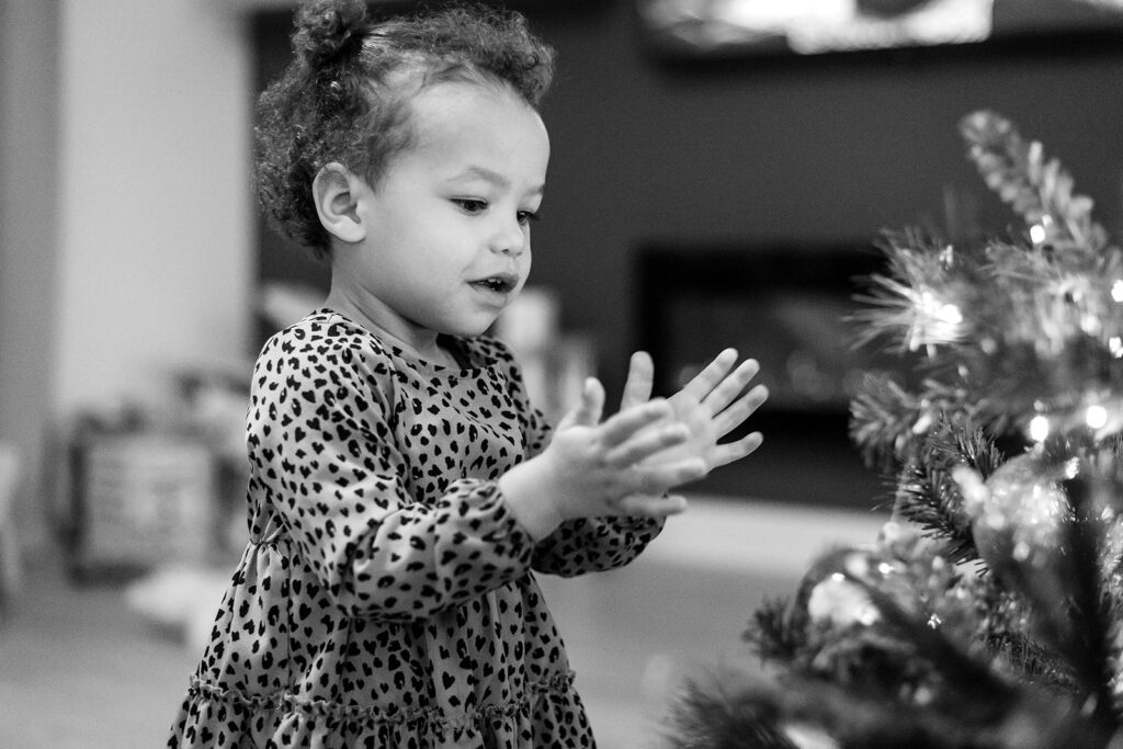 little girl decorating the christmas tree