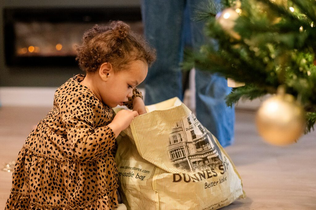 toddler decorating the christmas tree at home