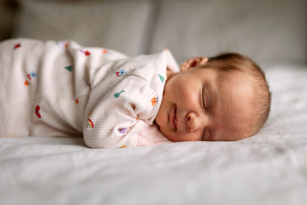 portrait of a newborn asleep on the family bed in a Dublin home