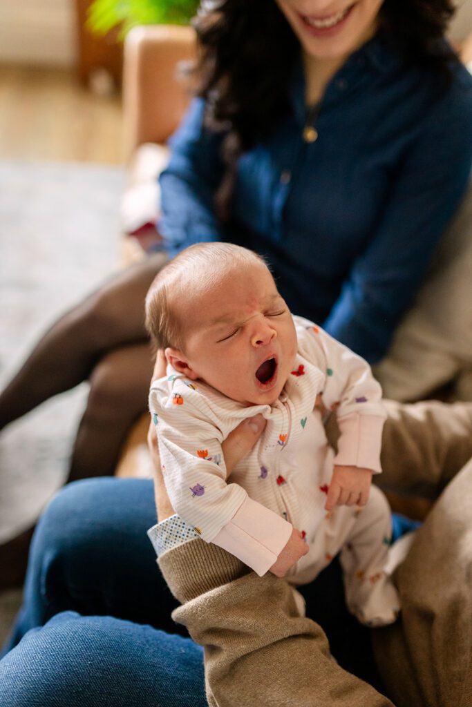 father holding his newborn daughter during an in-home newborn photos in Inchicore Dublin 8