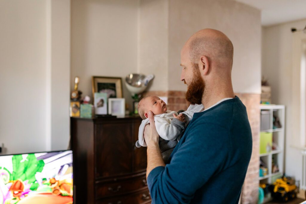 father holding newborn child