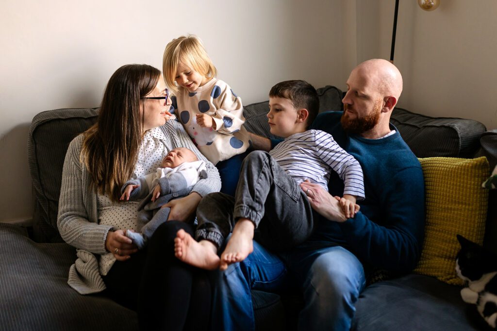candid photo of a family at home, documentary newborn photography vs studio