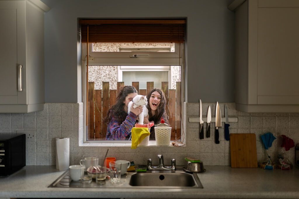 kids and their cat playing at home