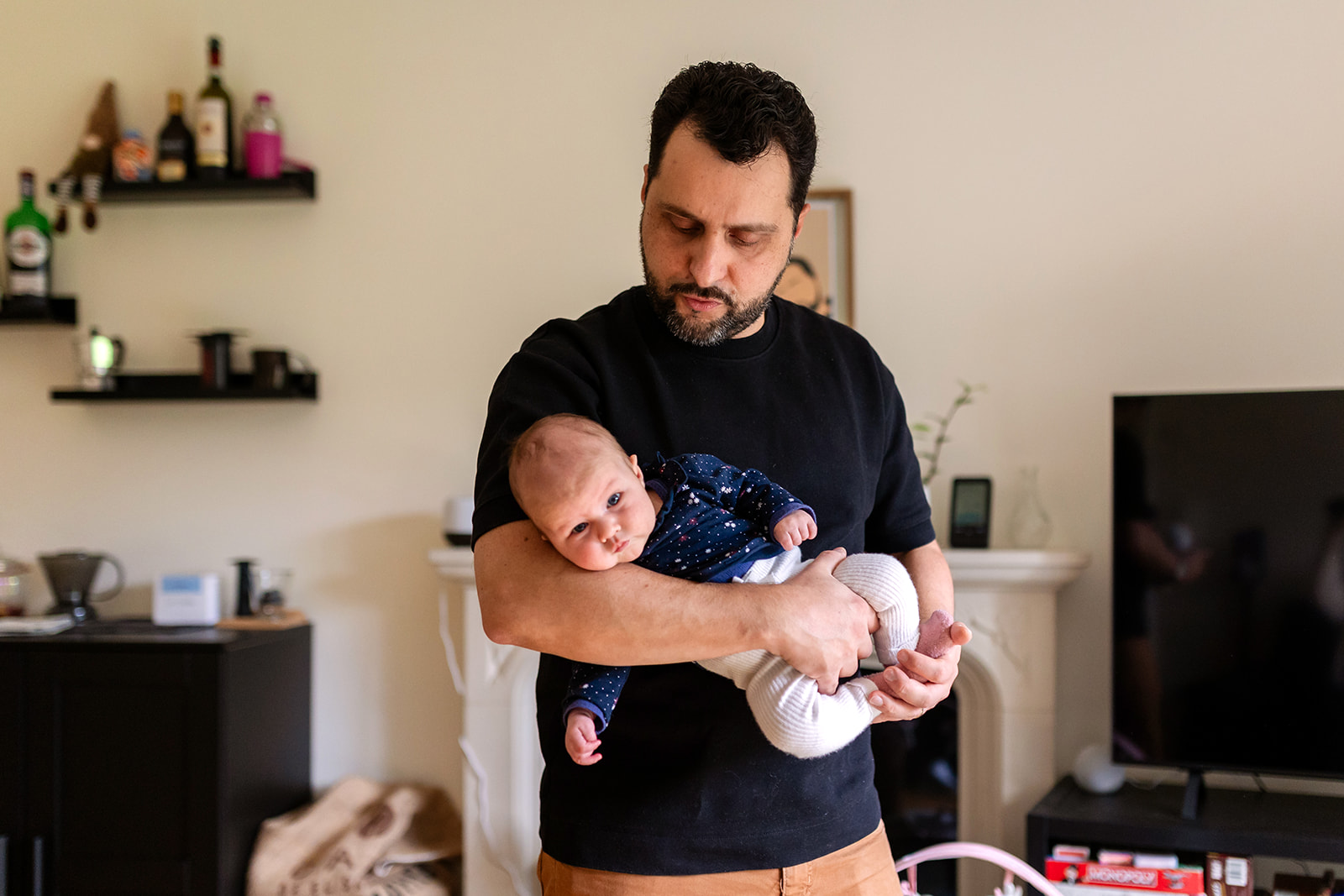 father holding his newborn baby