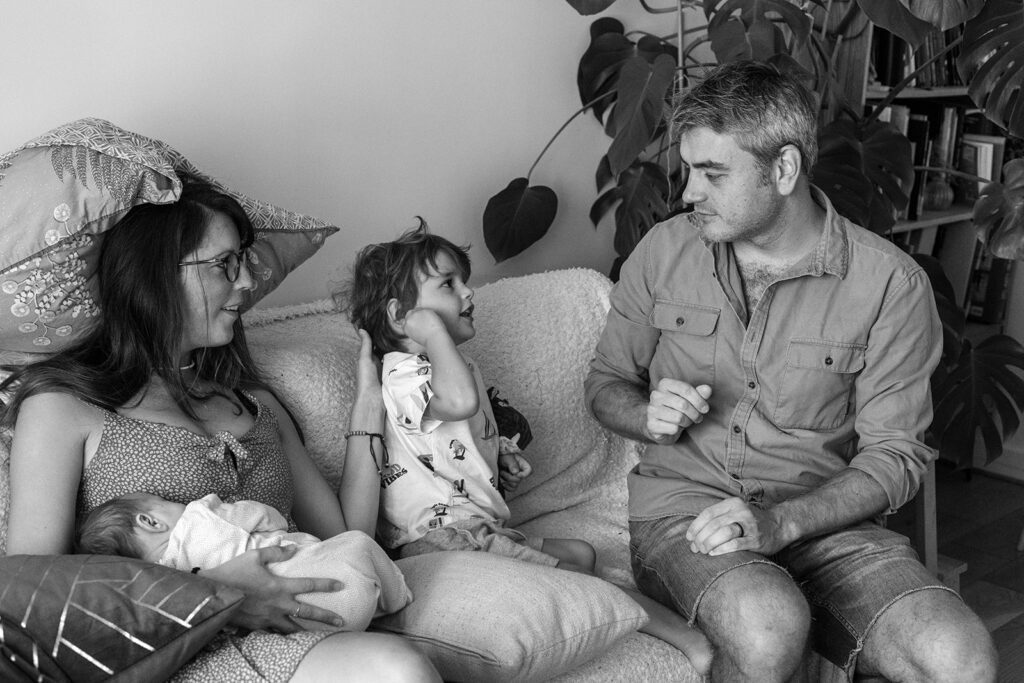 family with small kids playing at home