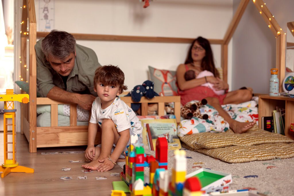 family playing at home in a real, cute and messy child room