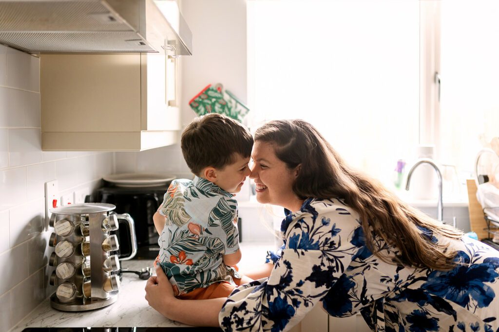 mom and kid cuddling in their kitchen, small and messy home family photos Dublin