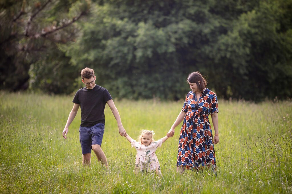 family walking hand in hand at the park