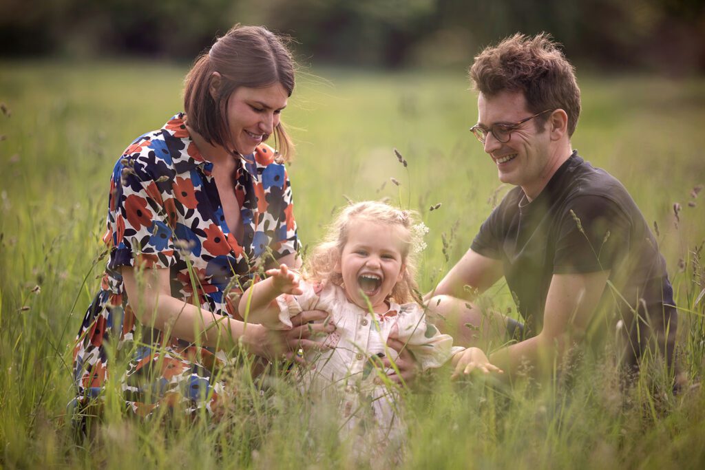 family posing at the park for a maternity photographer in Dublin