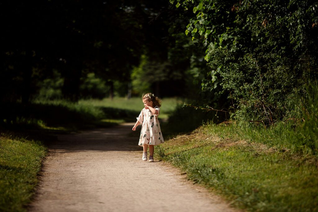 little girl playing at the park on a sunny day