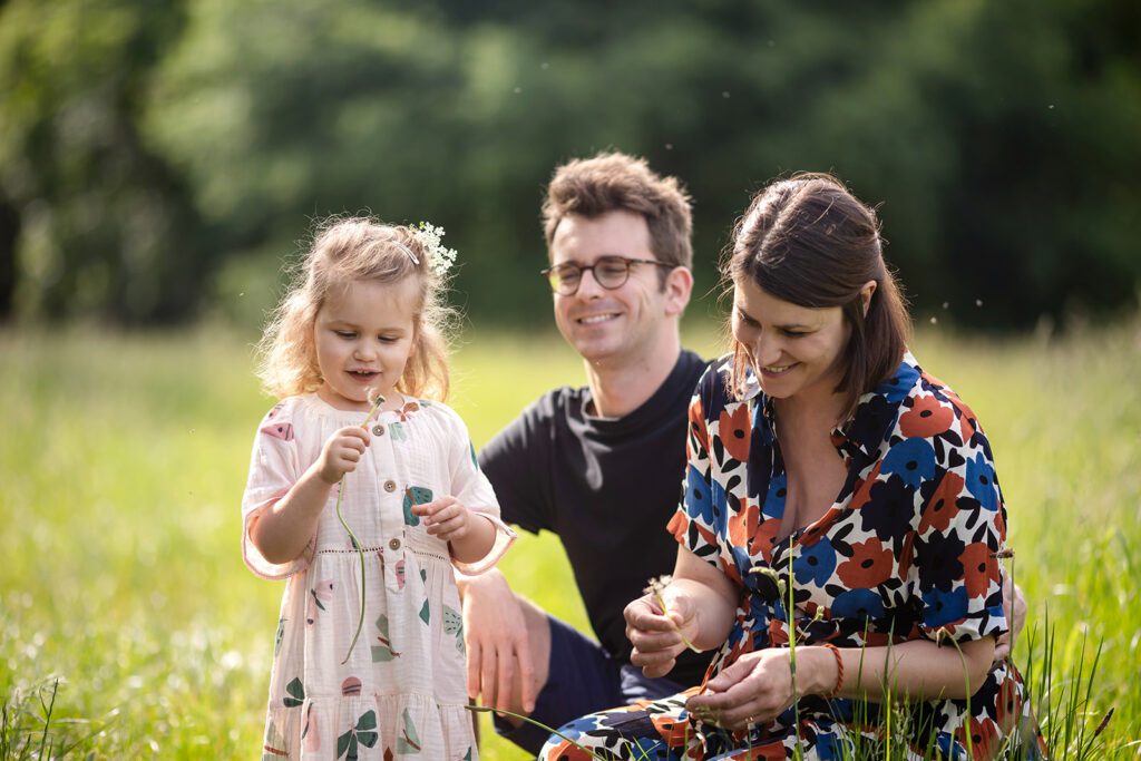 family smiling and playing in the park
