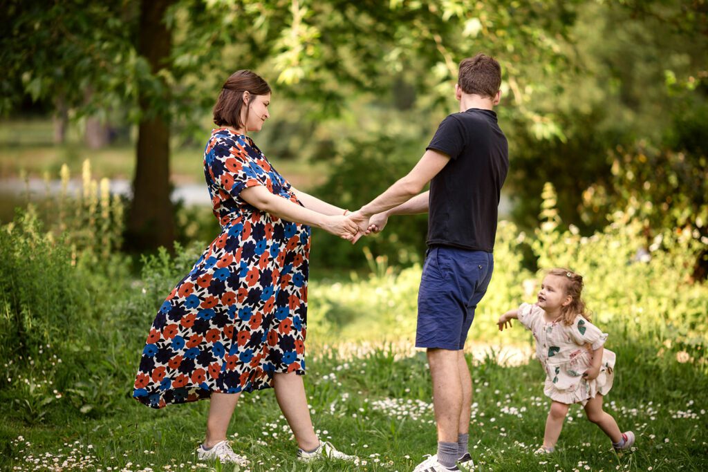 family dancing and playing in a park